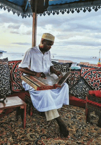 The Zanzibar People:History, Culture, and Traditions Zanzibar music ( Said Bhai playing ganun)-thisistanzania.com png